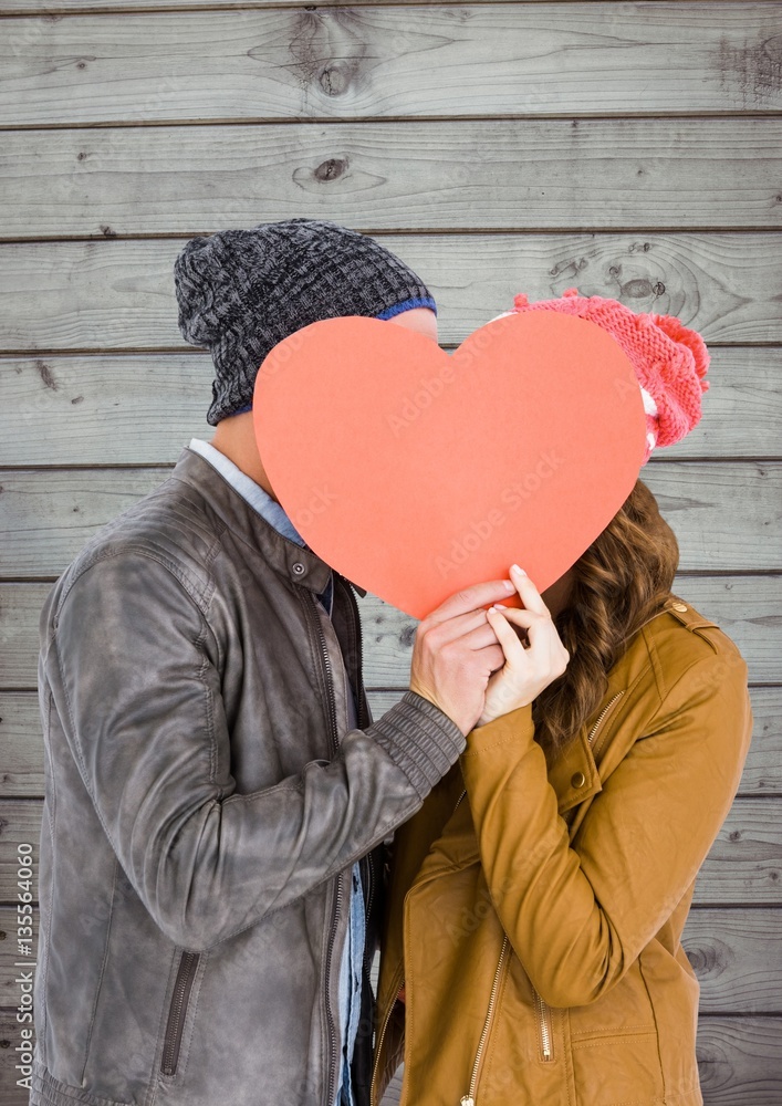 Romantic couple holding heart shape and kissing each other