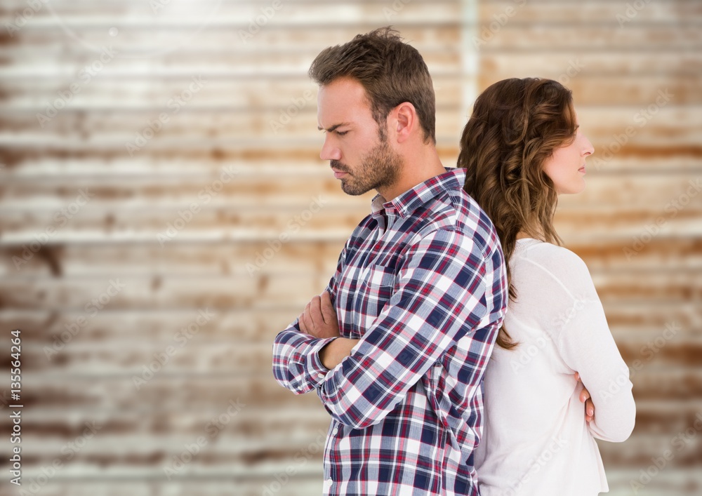 Unhappy couple standing back to back