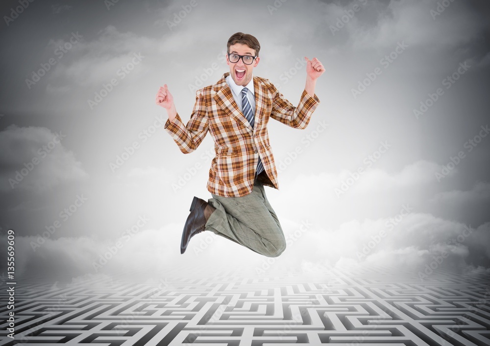 Businessman jumping over maze