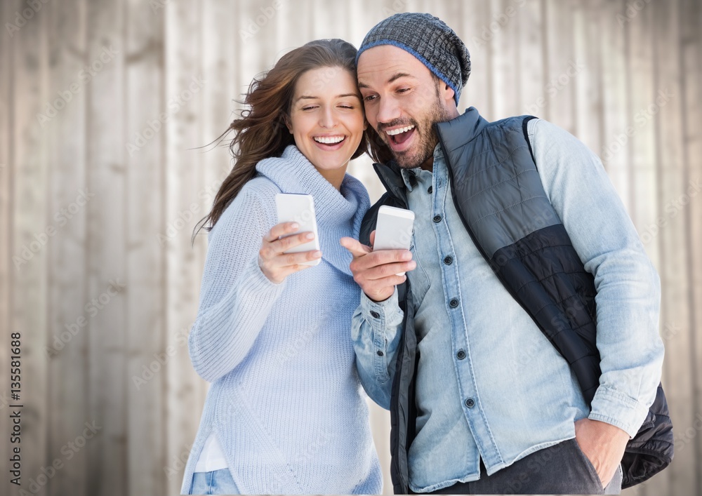 Happy couple using mobile phone