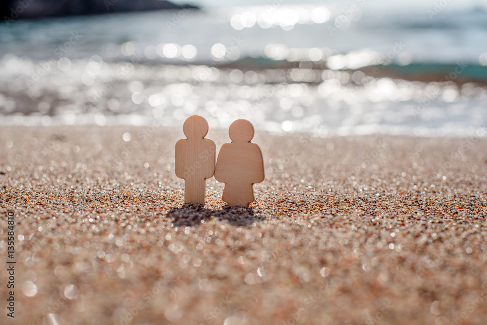 romantic symbol of man and woman on the beach 