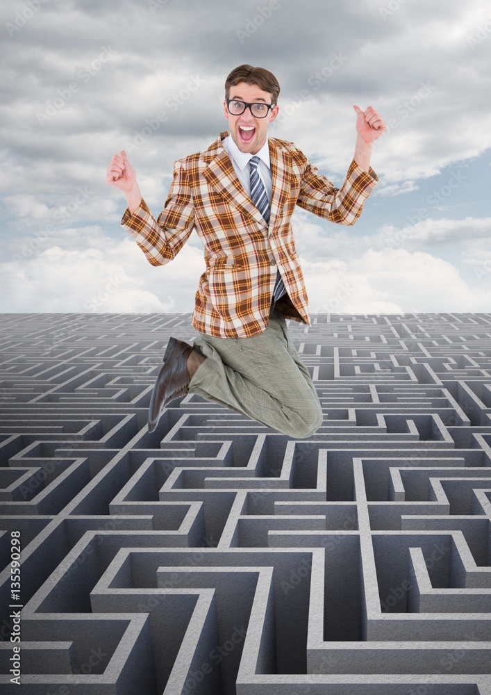 Businessman jumping over maze