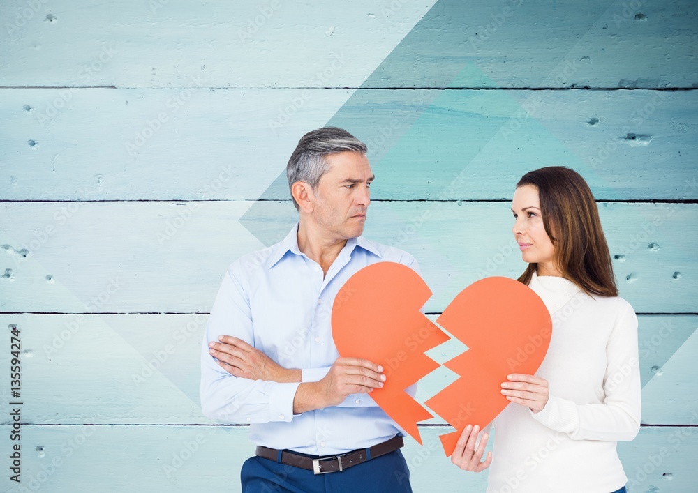 Mature couple holding a broken heart