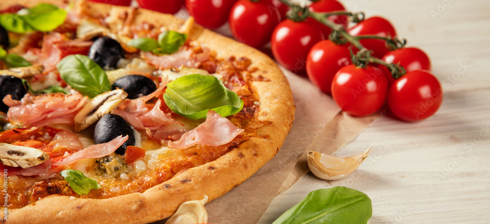 Pizza with ingredients served on wood