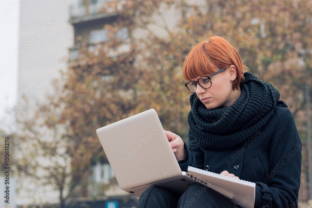 Girl student doing homework outdoor