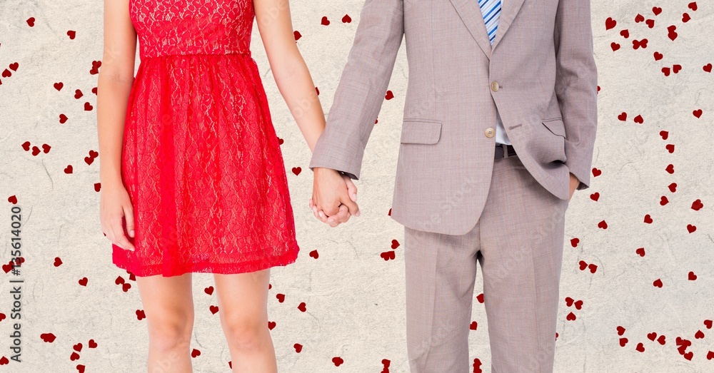 Mid-section of couple holding hands