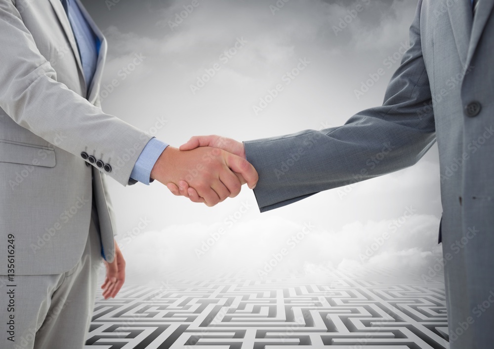 Mid-section of businessman shaking hands