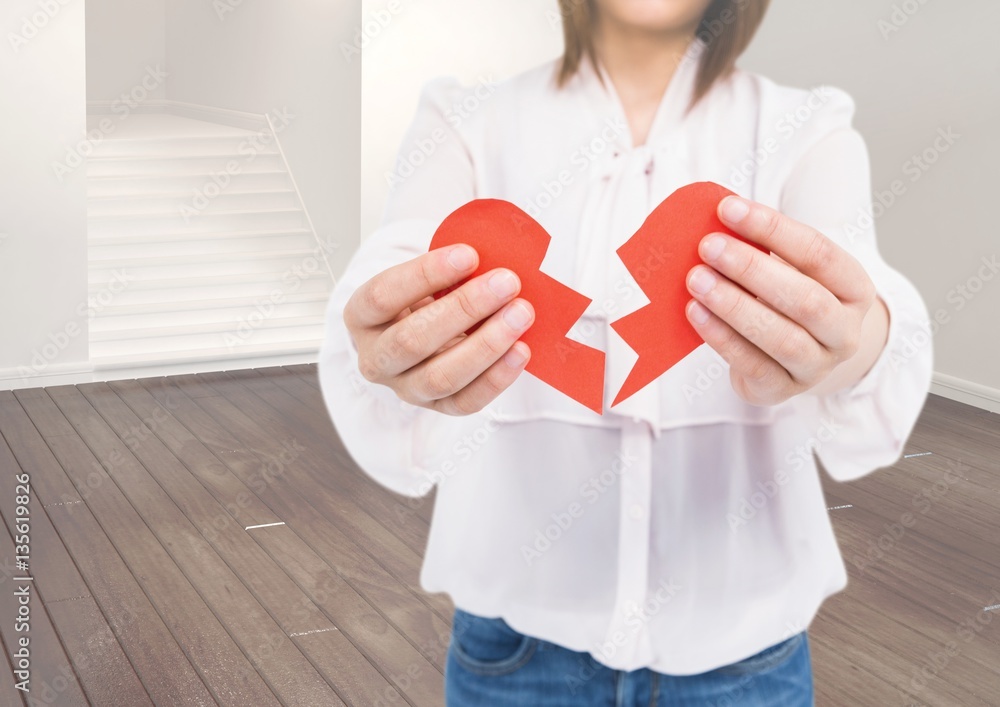 Mid-section of woman holding broken hearts