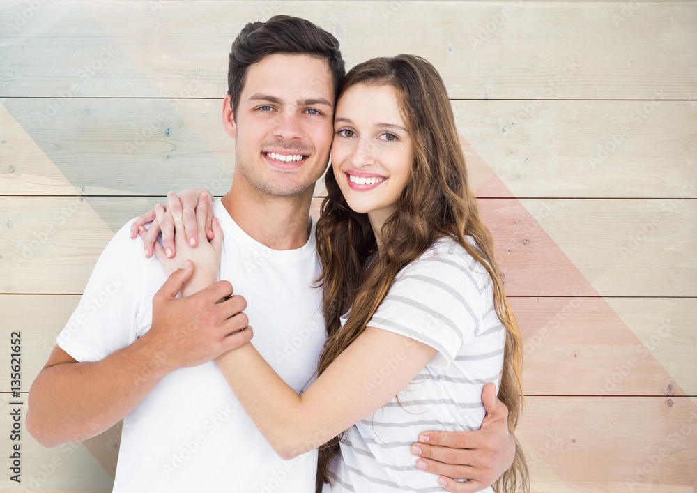 Portrait of happy couple standing with arm around