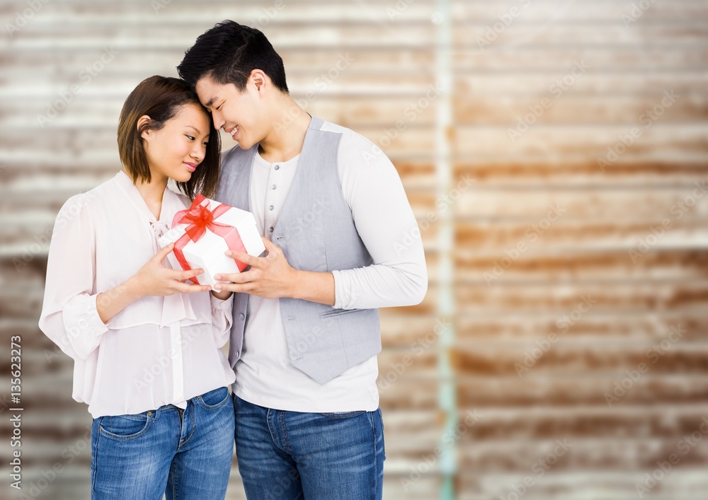 Romantic couple holding gift box