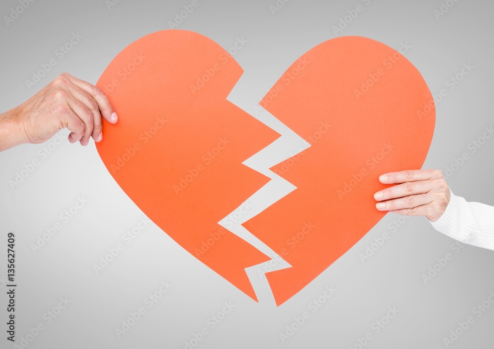 Hand of couple holding broken hearts