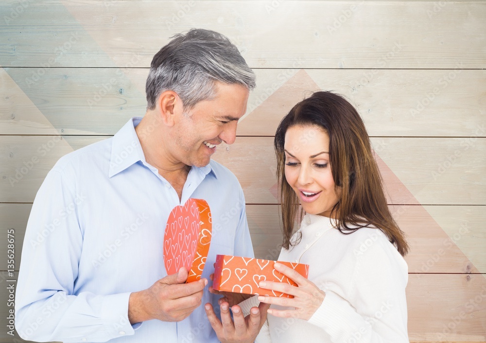 Mature man giving surprise gift to woman