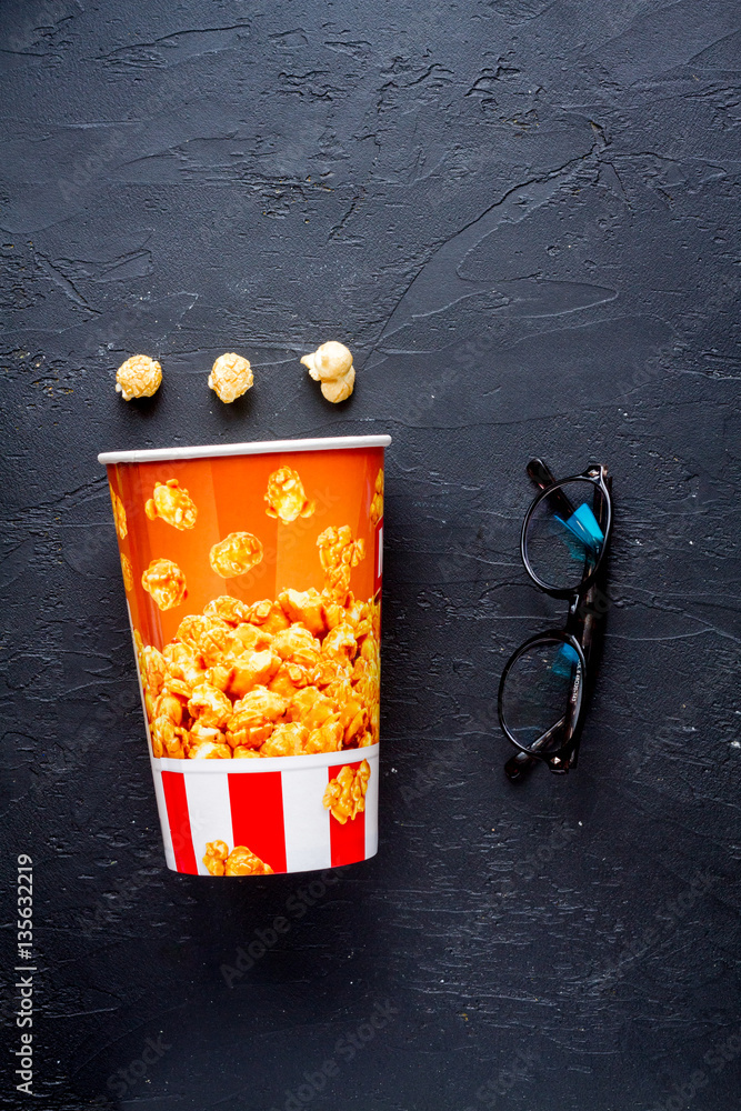 concept of watching movies with popcorn top view dark background