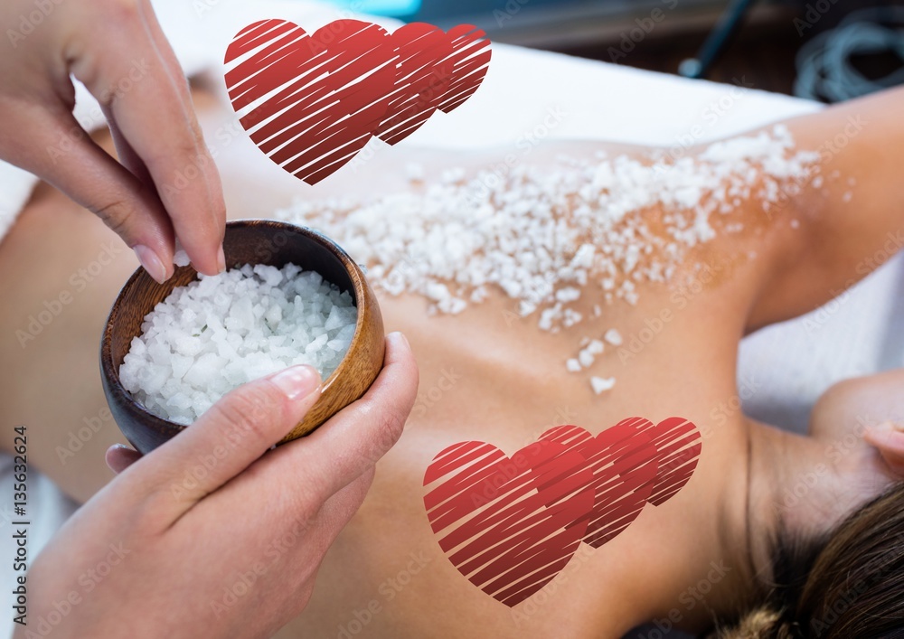 Woman getting sea salt massage on back