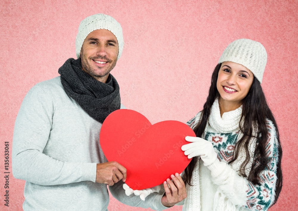 Portrait of couple holding red heart