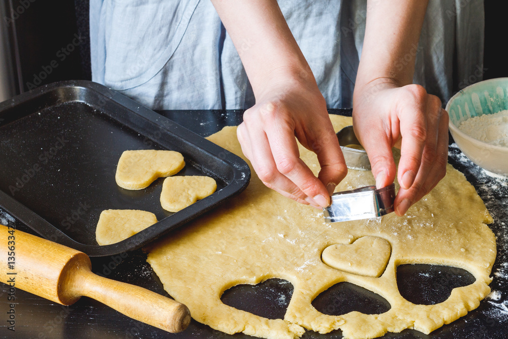 cooking homemade cookies with hands on dark background