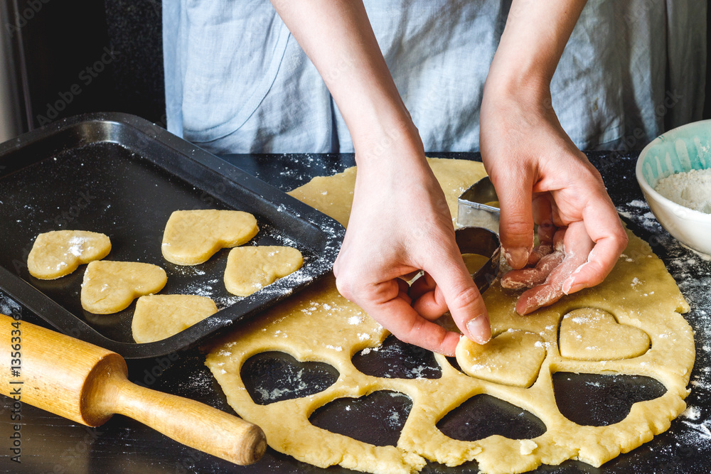 cooking homemade cookies with hands on dark background