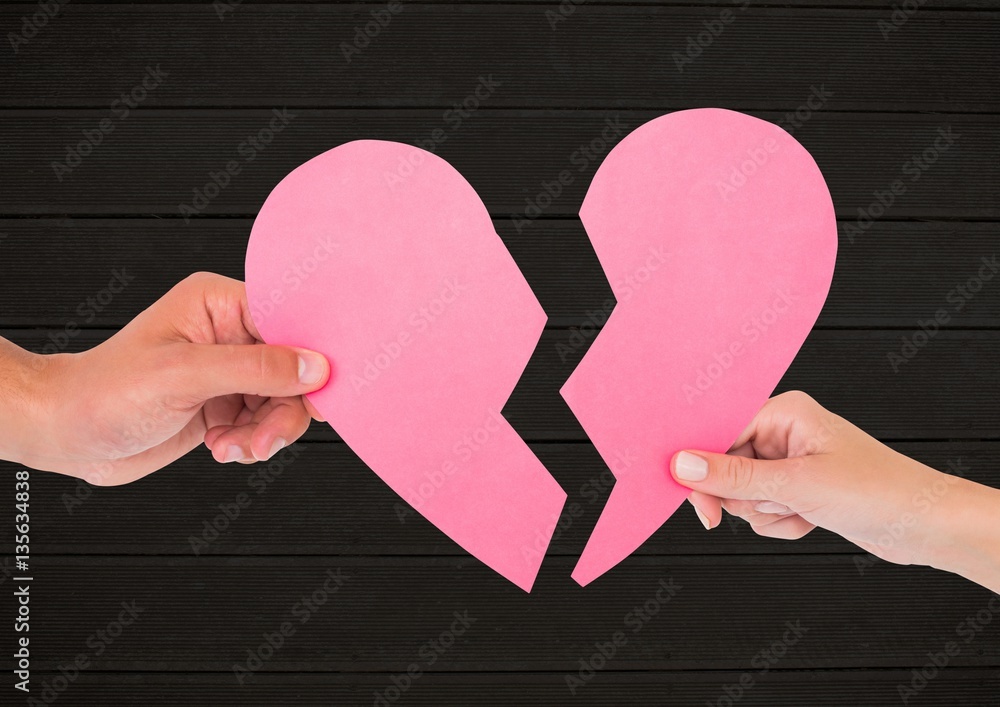 Hands of couple holding broken heart