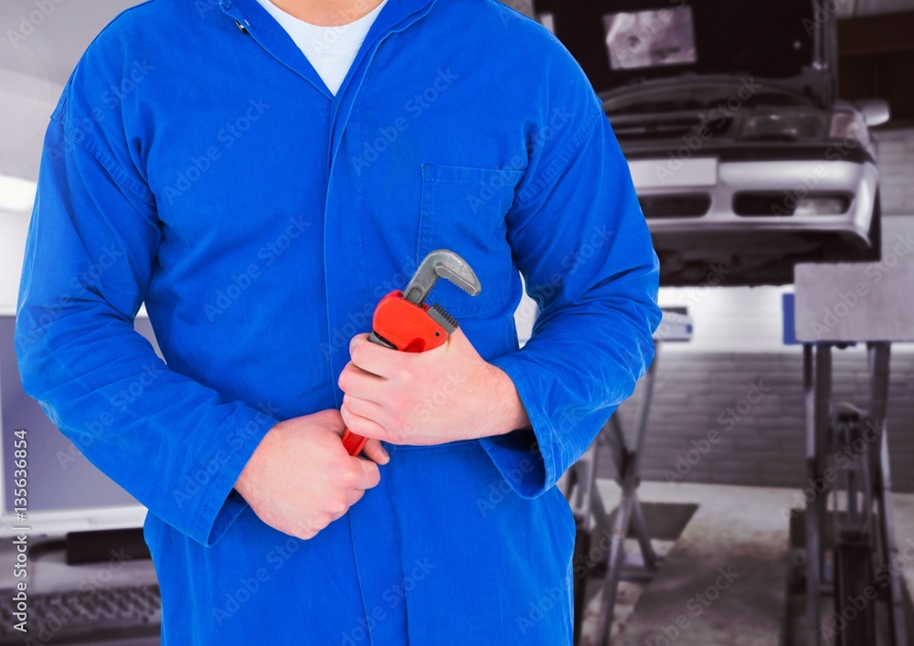 Mid section of mechanic holding pipe wrench