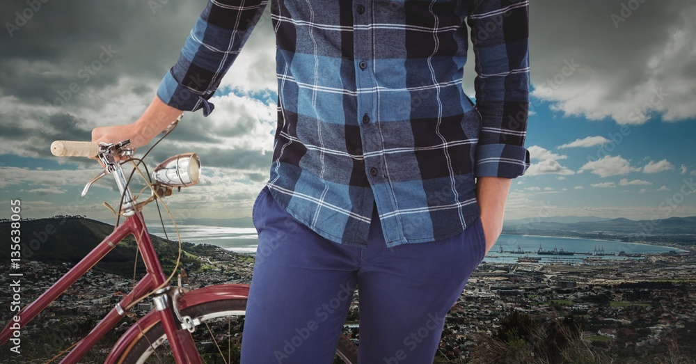 Man standing with bicycle near coastline