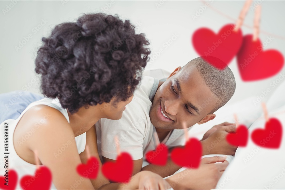 Romantic couple lying on bed in bedroom at home