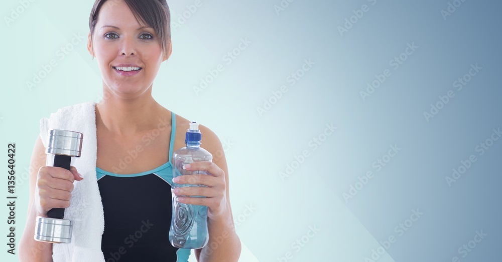 Portrait of fit woman holding dumbbell and water bottle