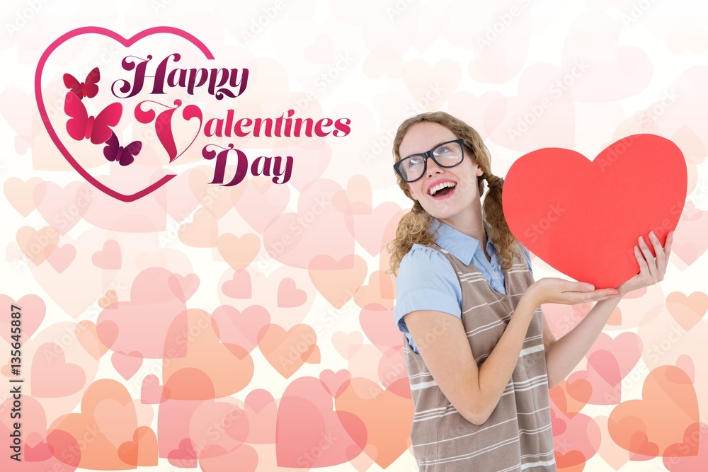 Composite image of love message and nerd woman holding red heart