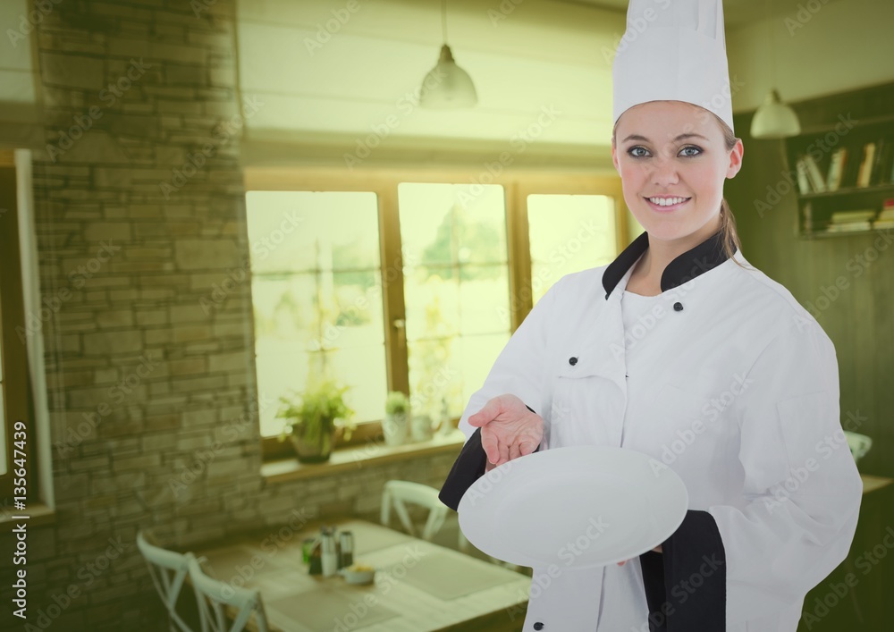 Portrait of smiling female chef holding a plate