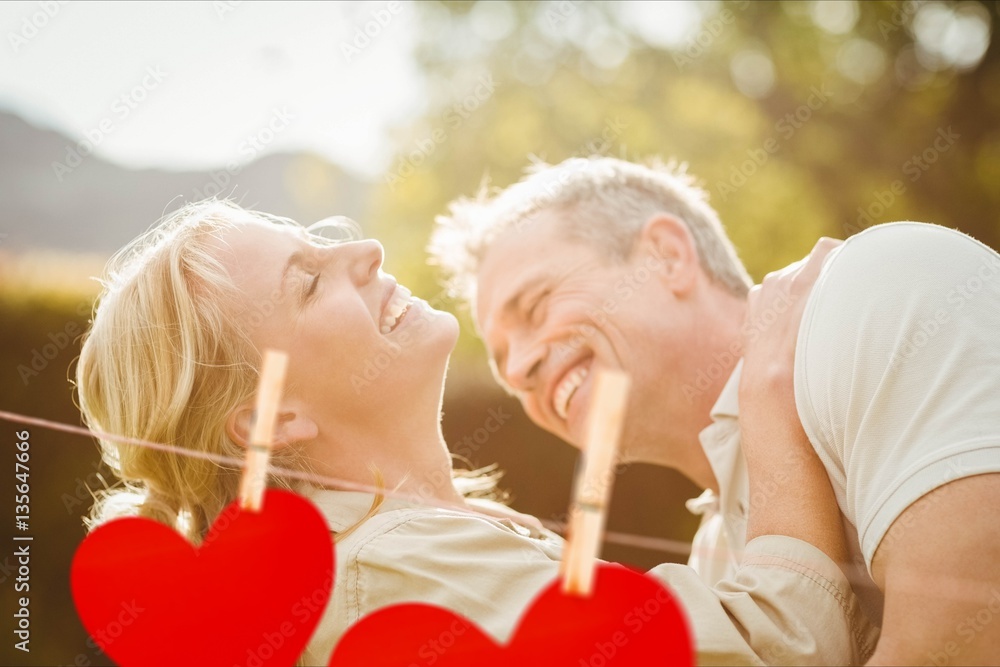 Red hanging heart and couple embracing each other