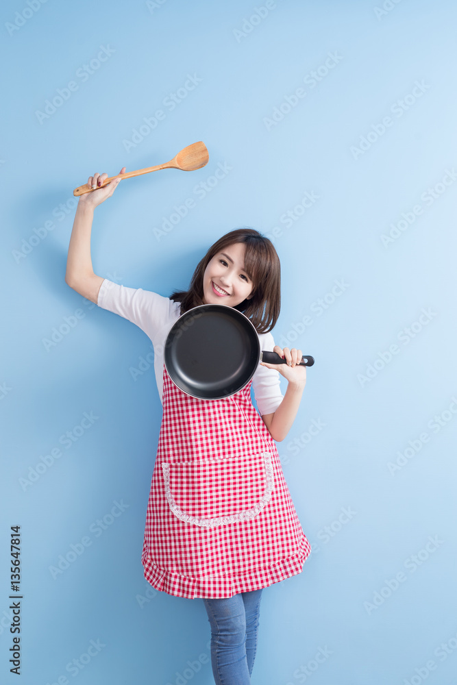 housewife take wok and spoon