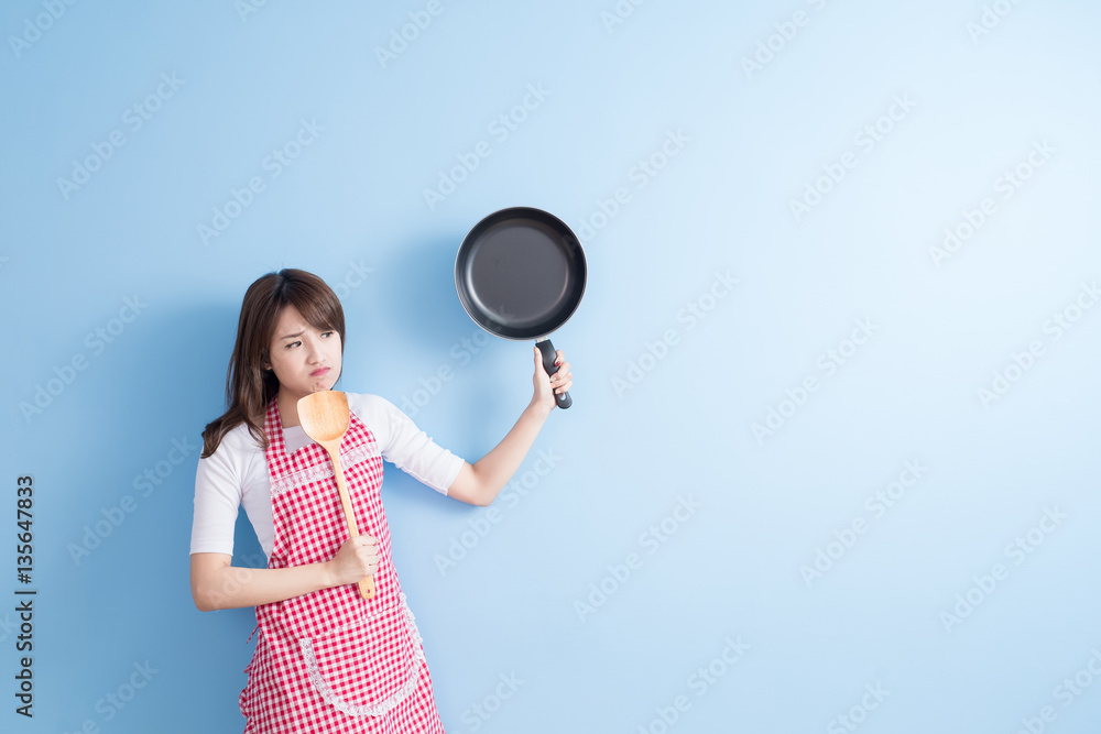 housewife take wok and spoon