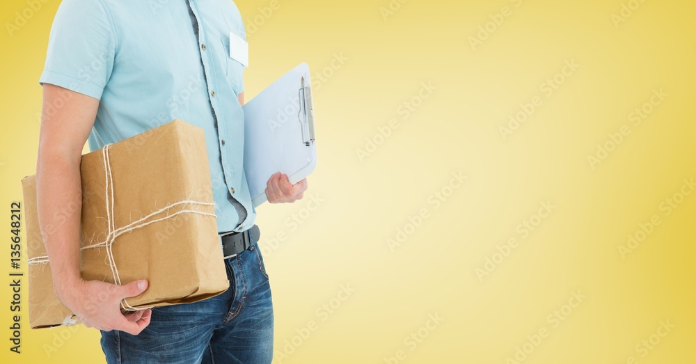 Mid section of delivery man holding parcel and clipboard