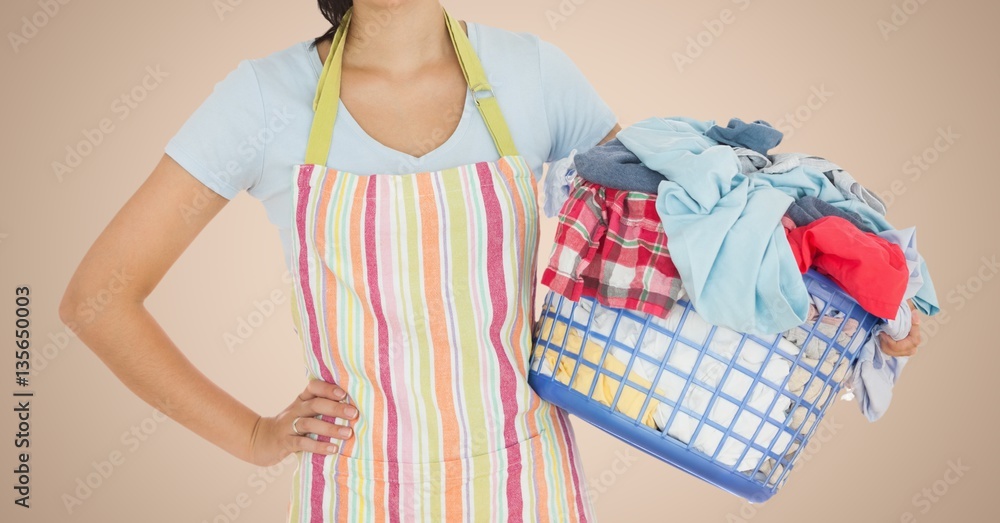 Mid section of woman holding basket full of clothes