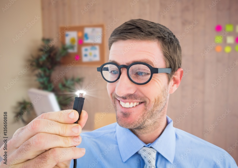 Businessman holding cable with flare in office