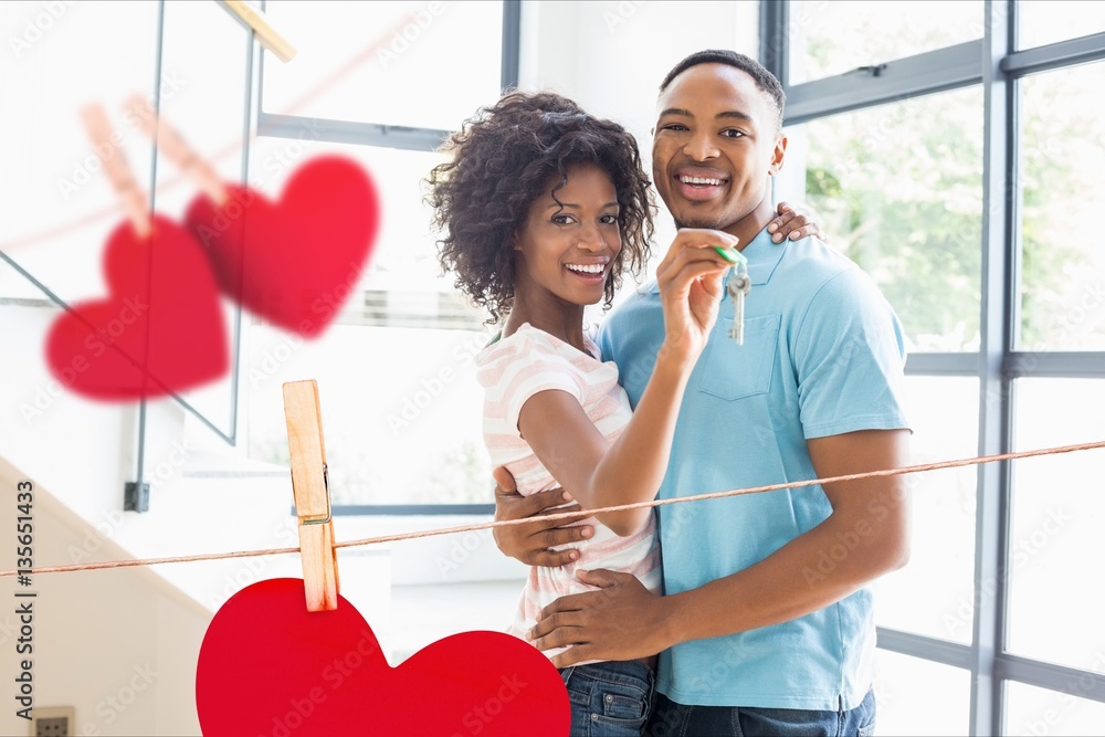 Portrait of happy couple showing new home key