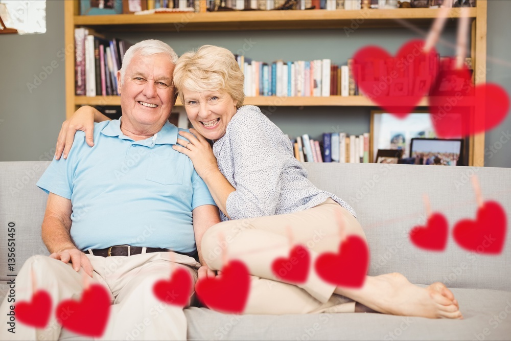 Portrait of senior couple embracing on sofa