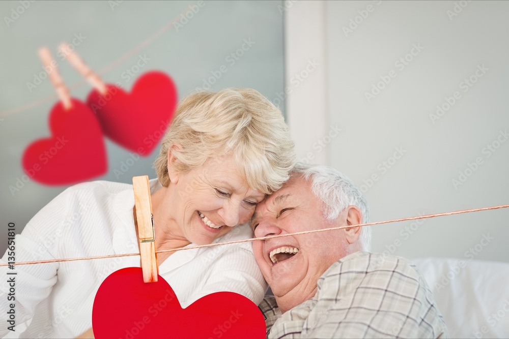 Senior couple embracing on sofa