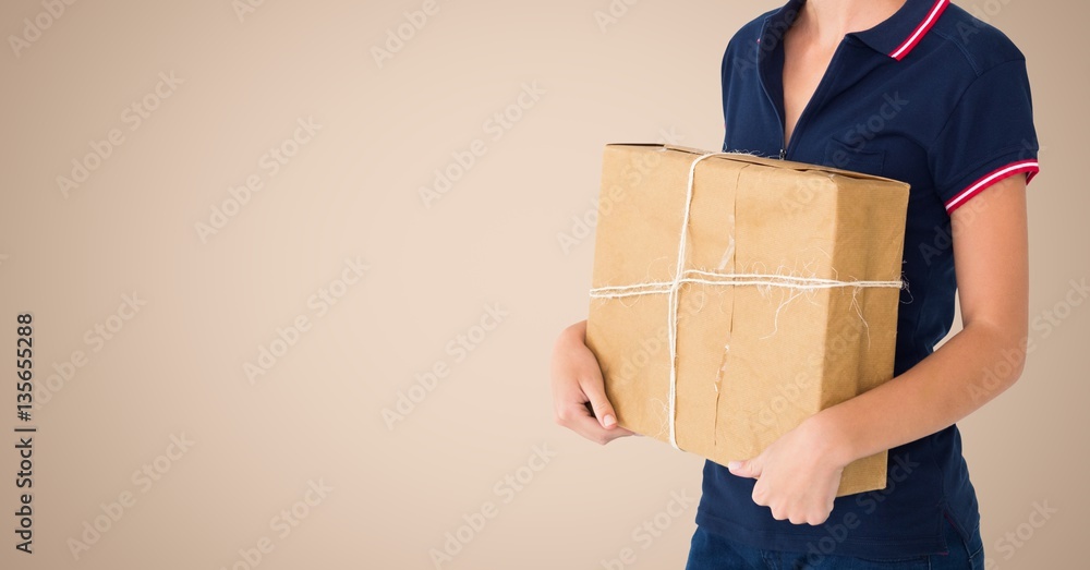 Woman holding a parcel against beige background