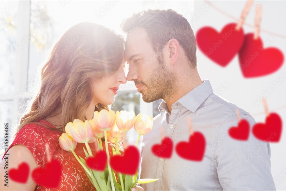 Couple embracing each other with red hanging hearts