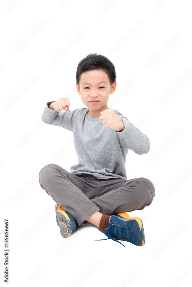 Young asian boy sitting over white