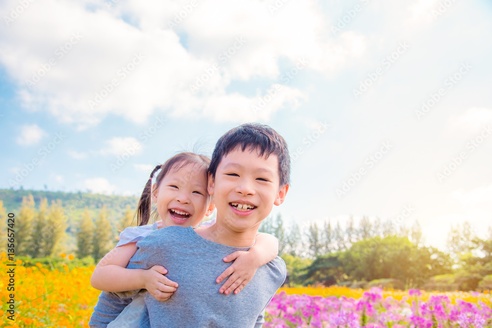 Young asian sibling happy in flower garden