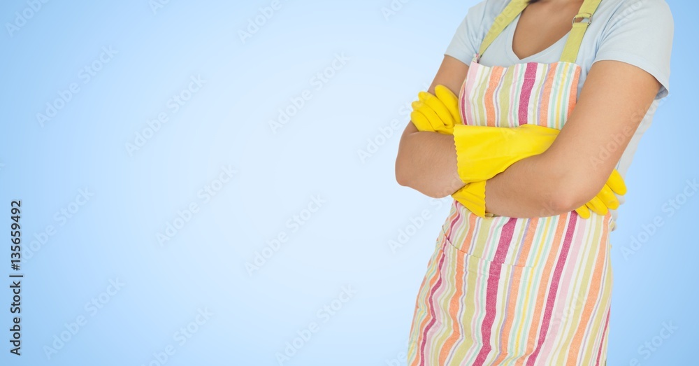 Woman in apron standing with arms crossed