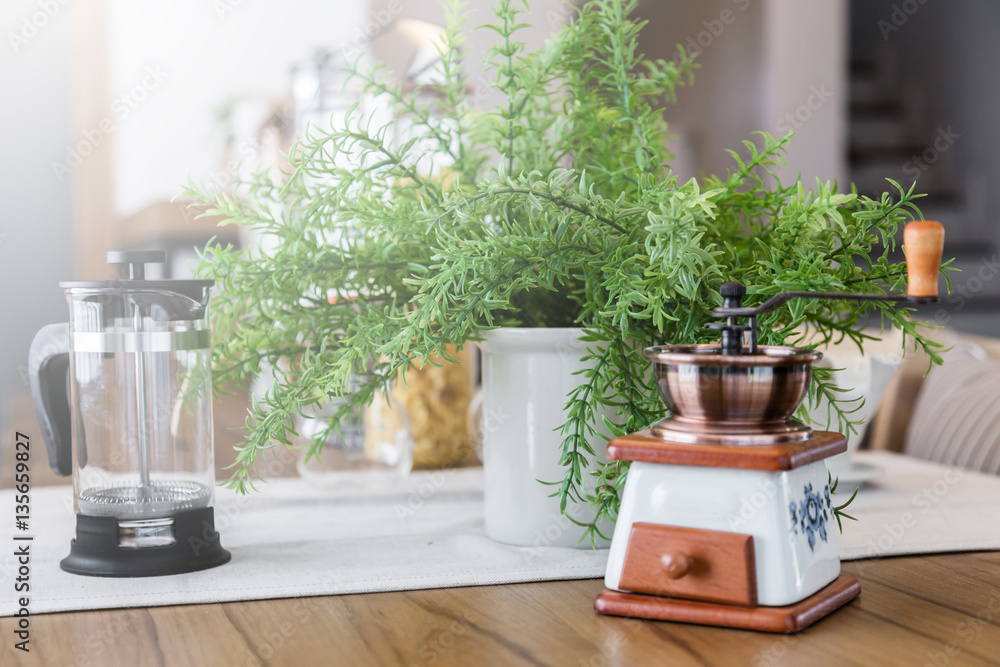 set of tea or coffee with small teapot on wooden table with room