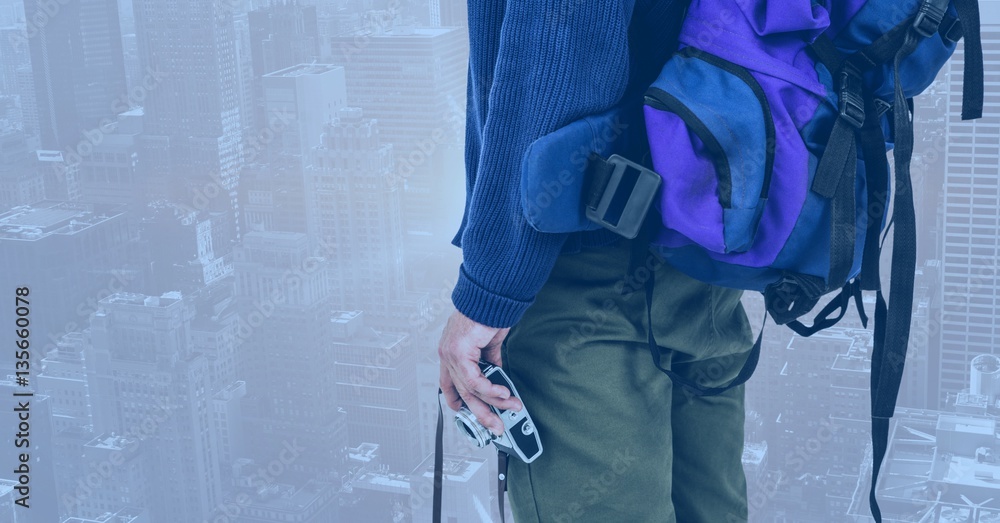 Woman with backpack and camera against cityscape background