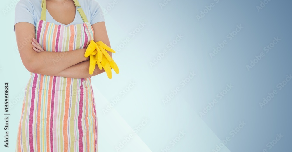 Mid section of female cleaner with yellow gloves