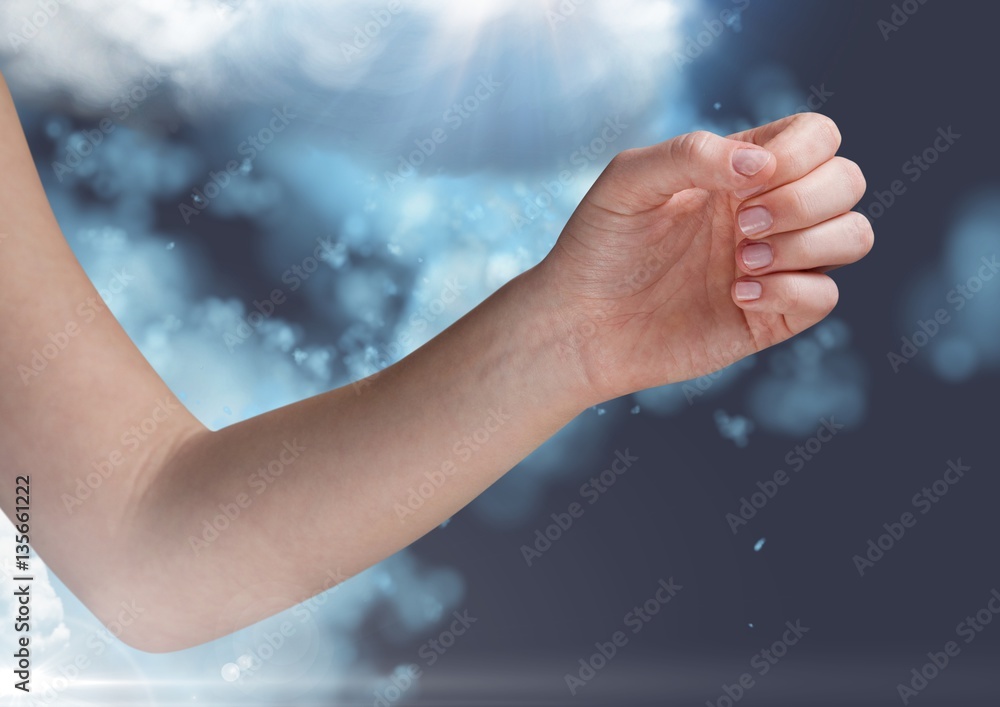 Digitally generated image of hand againt cloud