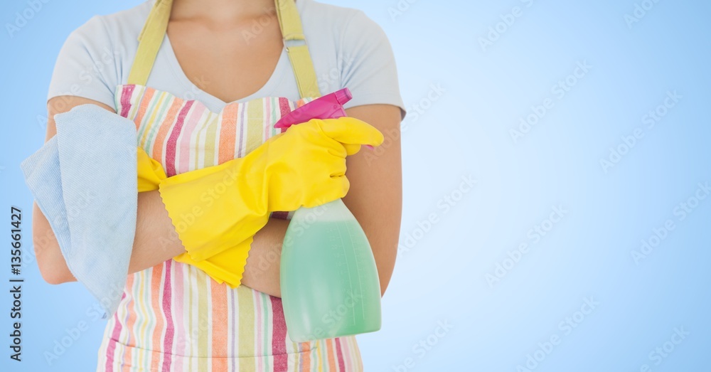 Mid section of female cleaner with spray bottle