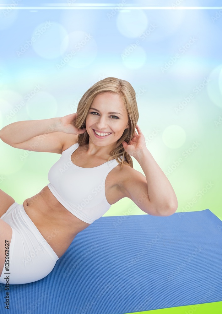 Beautiful woman performing yoga on blue mat