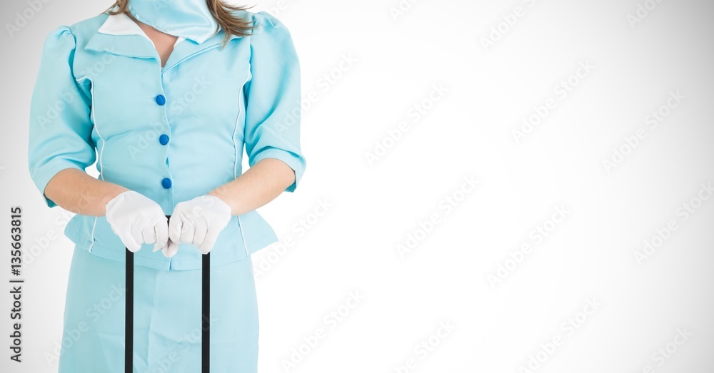 Mid-section of air hostess holding a suitcase