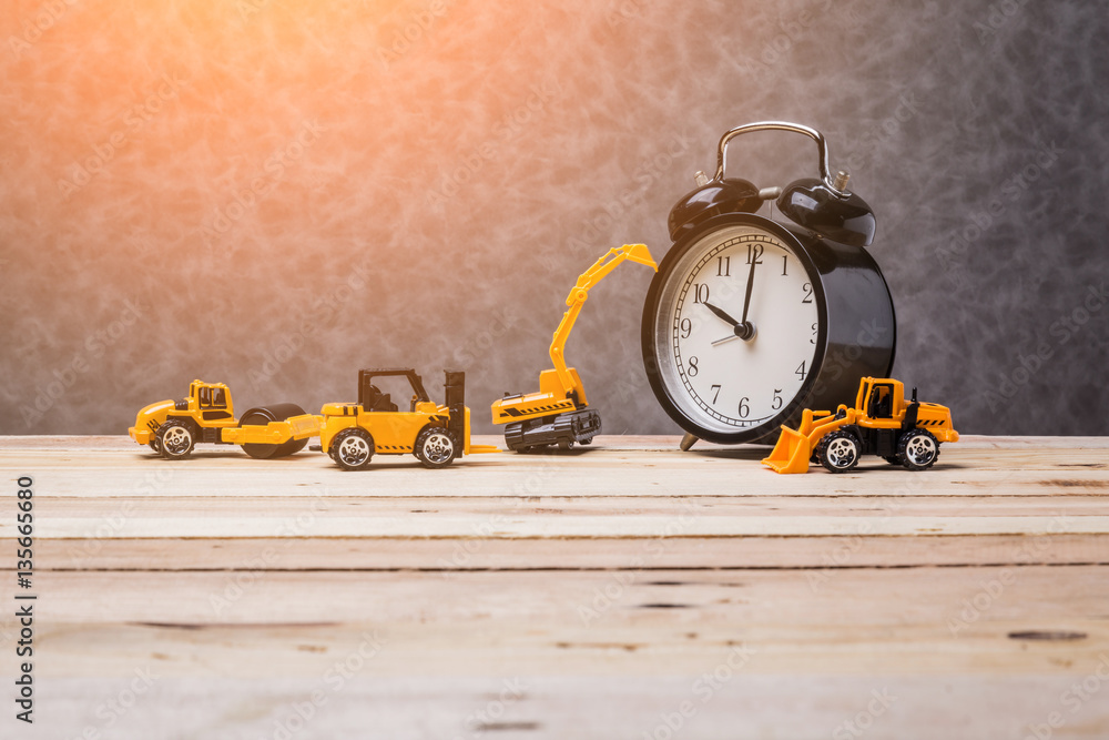 vintage black alarmclock with toy car business construction idea